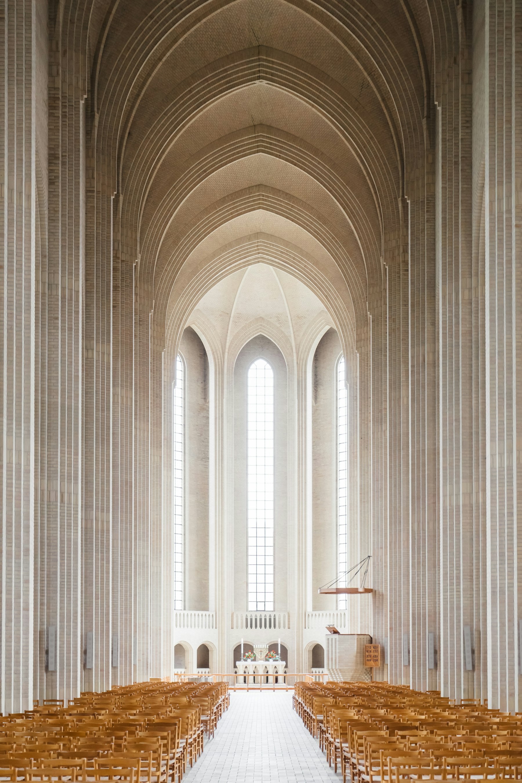 Rows of pews leading toward the altar in warm light